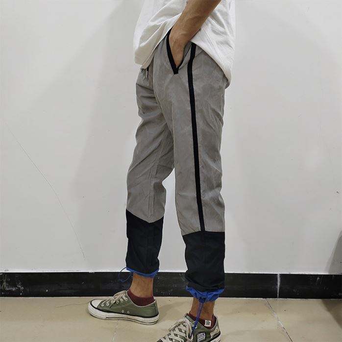Pantalones cargo para hombre del OEM Pantalones del bloque del color Pantalones de pista reflexivos de los hombres del diseño especial de la moda