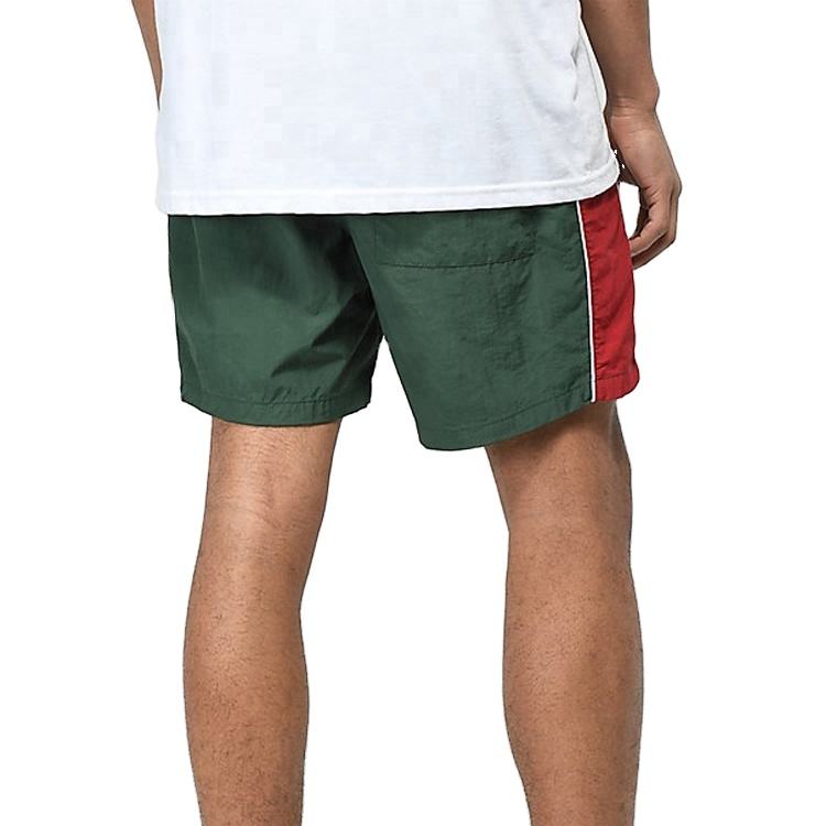 บริการ OEM ท่อตะเข็บสีขาวไนลอนธรรมดาสีเขียวมะกอกแบบกำหนดเองเหงื่อ ออกแบบกางเกงขาสั้นบอร์ดของคุณเองด้วยแถบด้านข้าง